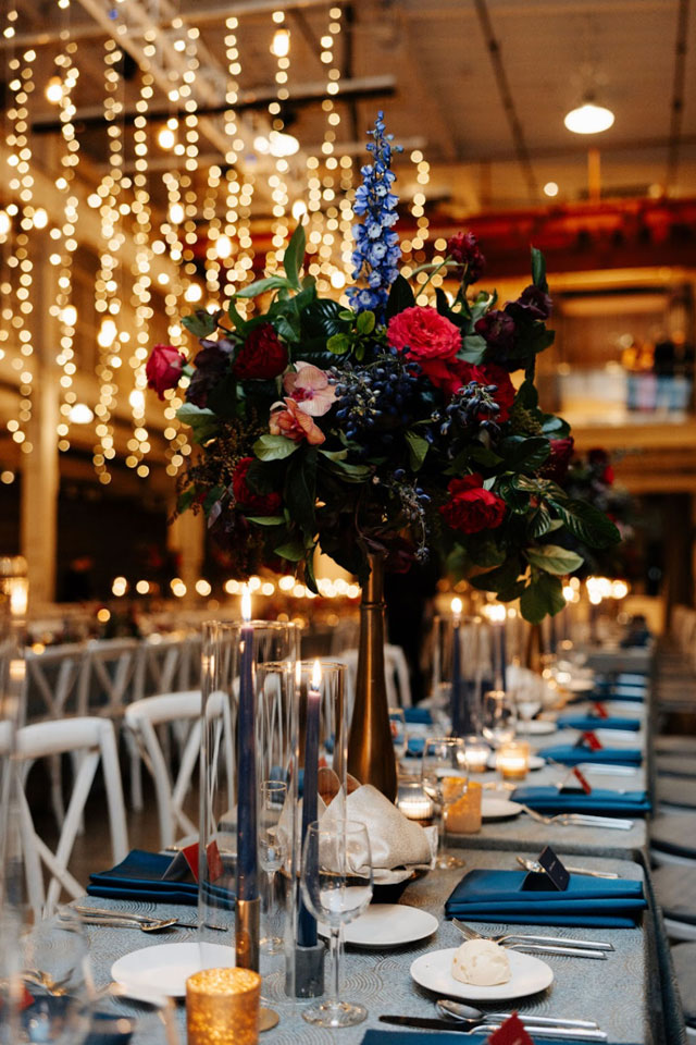 Romantic wedding table setting with florals and candlelight by Green Mangos Catering
